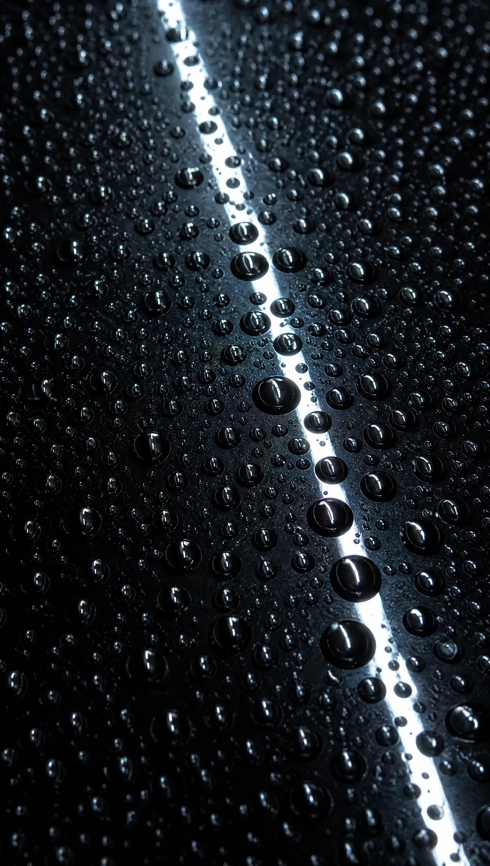 Beads standing on a black roof after a coating