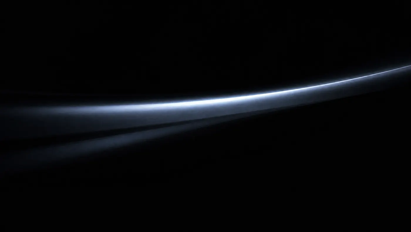 A single streak of light running across black paint